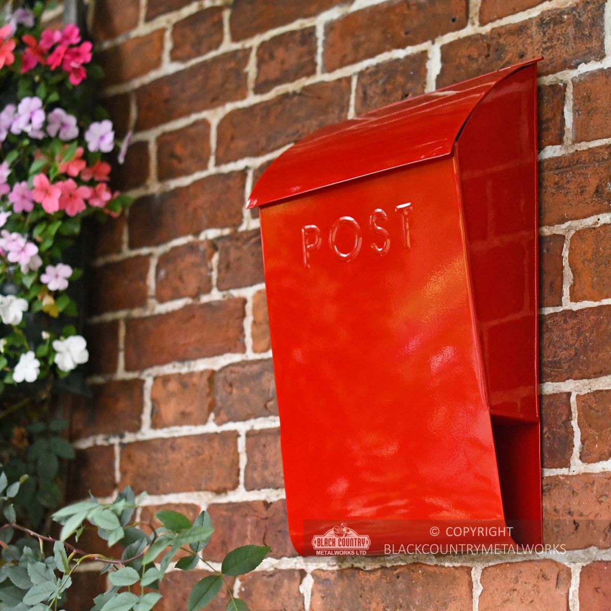 Red Letter box mounted brick on wall