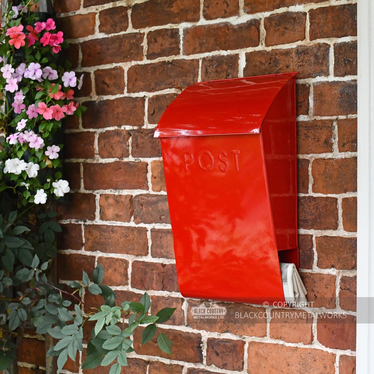 Robust wall mounted mail box with added newspaper holder