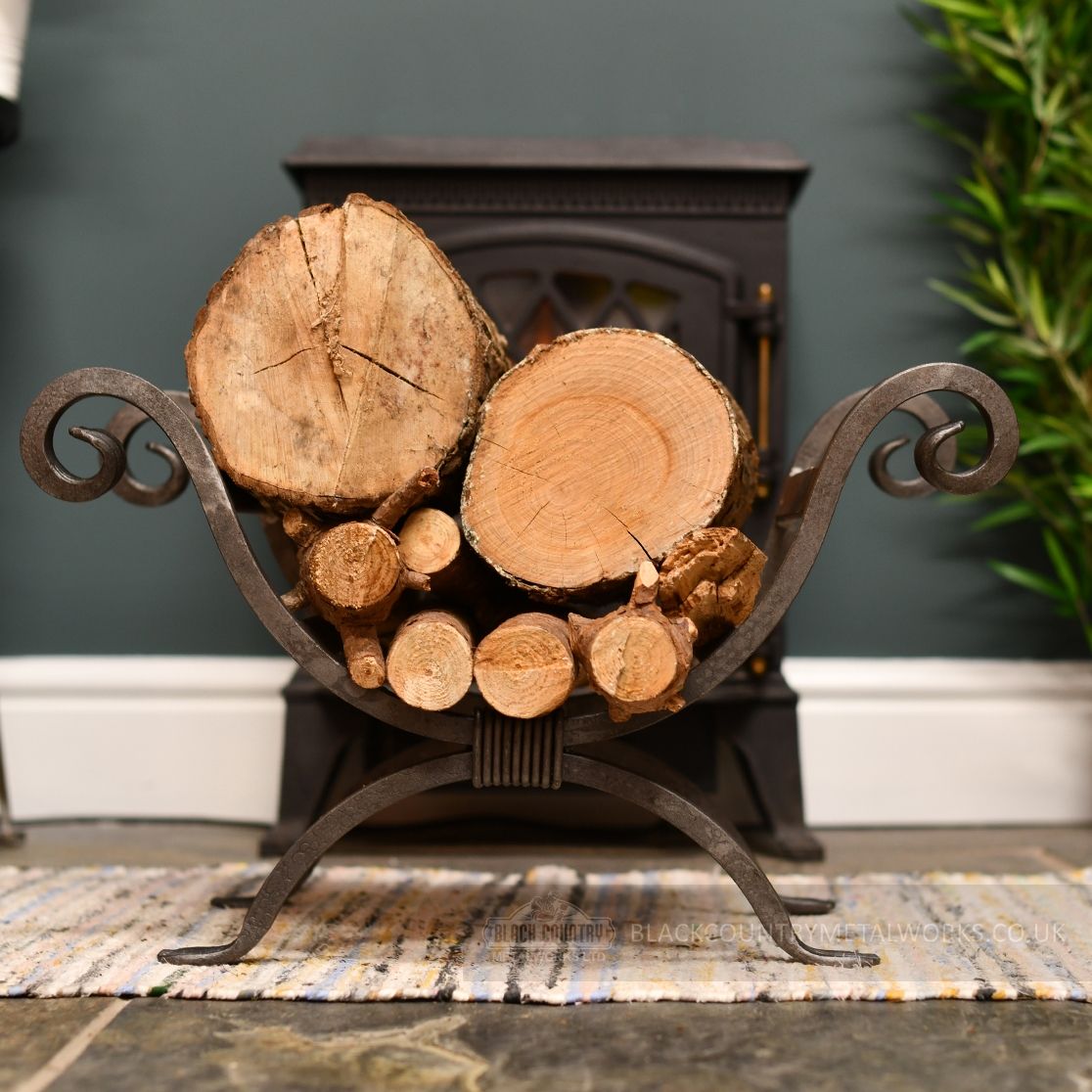Wrought iron scroll design log holder infront of fireplace