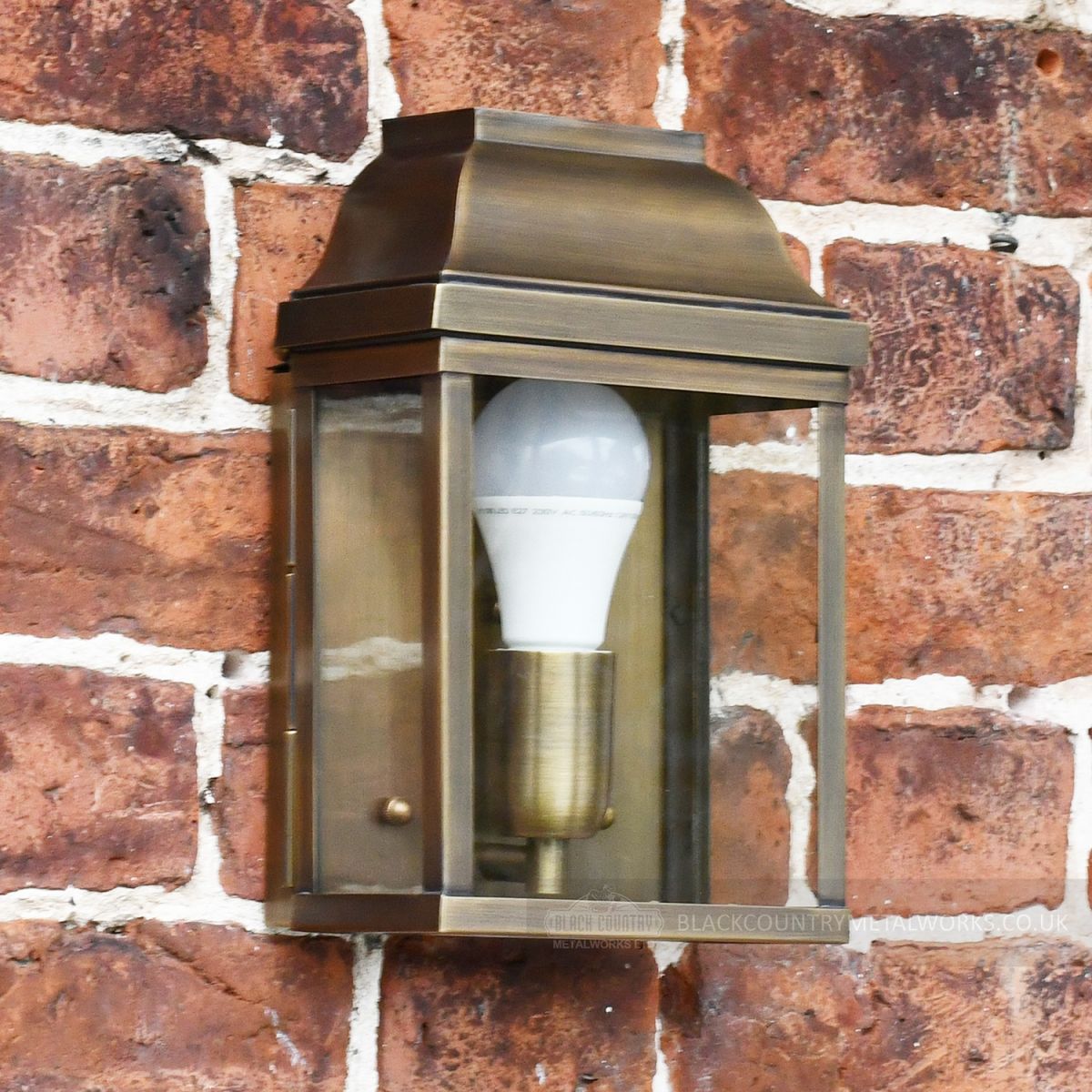 Antique Brass classic wall lantern on brick wall