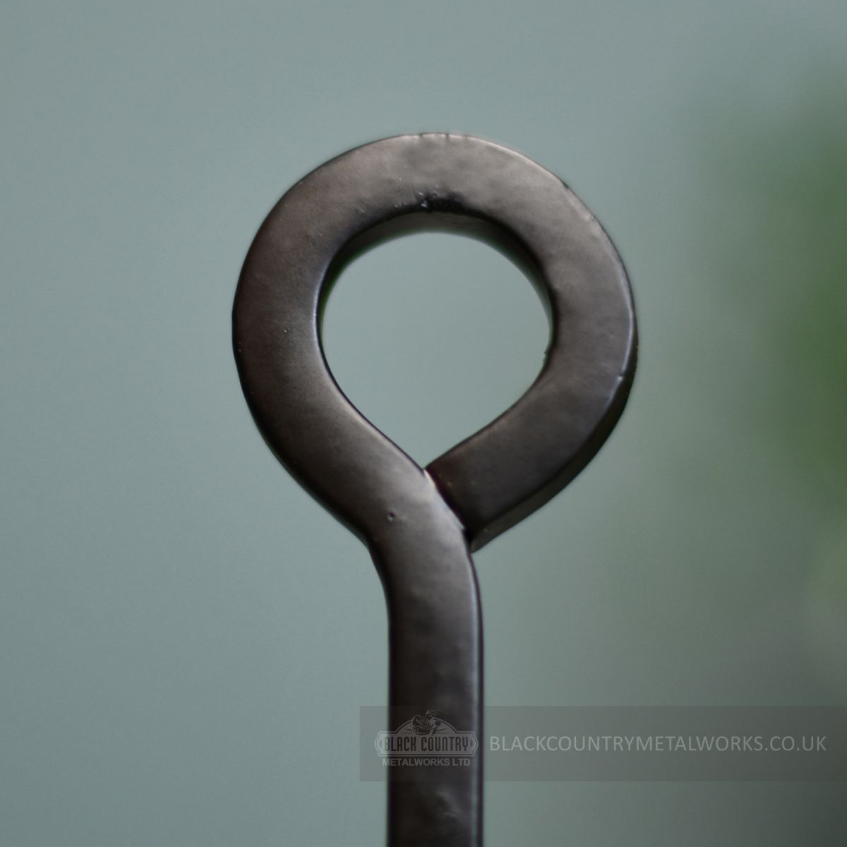 Looped handle on wrought iron toasking fork accessory