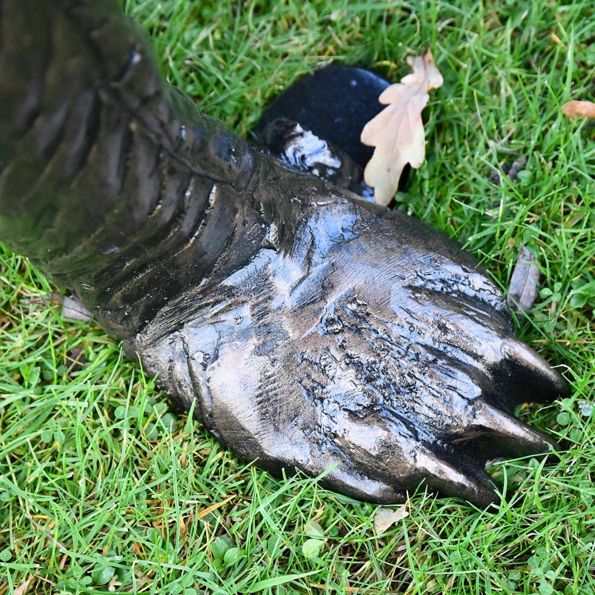 Close-up of the Antique Bronze Feet on the Bear Cub Close-up of the Antique Bronze Feet on the Bear Cub