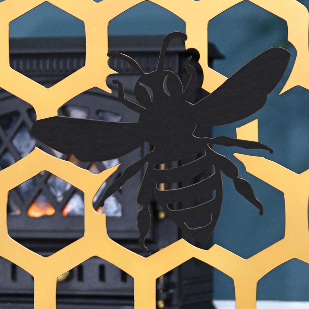 Black Coloured Bee on the Gold Bee Fireguard