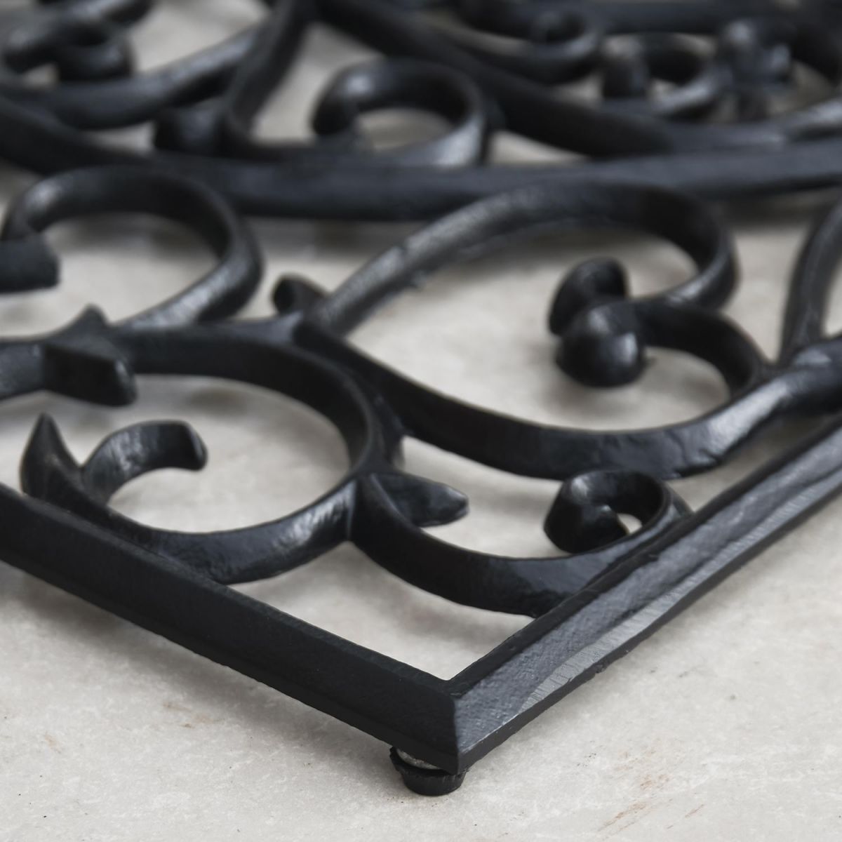 Close-up of the "Belleview" Rectangle Heart Doormat on a Tiled Floor