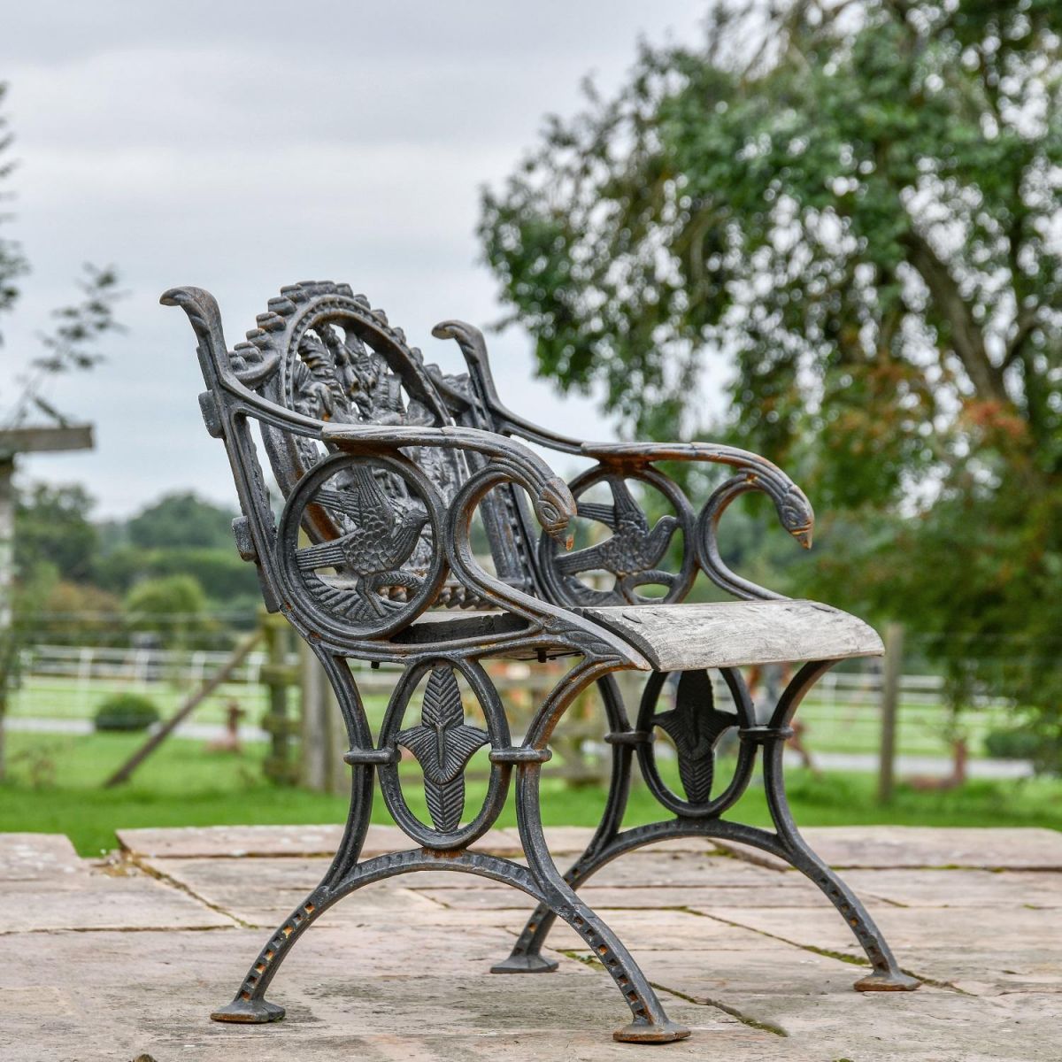 Side view of Aged Black Cast Iron "Dog" Single Seater Bench Side view of Aged Black Cast Iron "Dog" Single Seater Bench