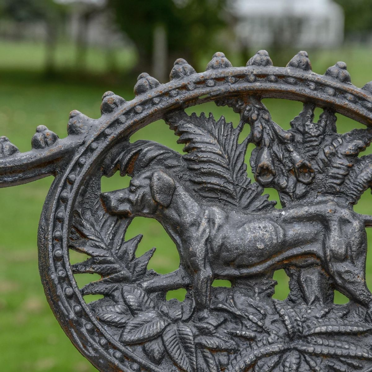 Close up of "Dog" Motif on Single Seater Aged Black Bench Close up of "Dog" Motif on Single Seater Aged Black Bench
