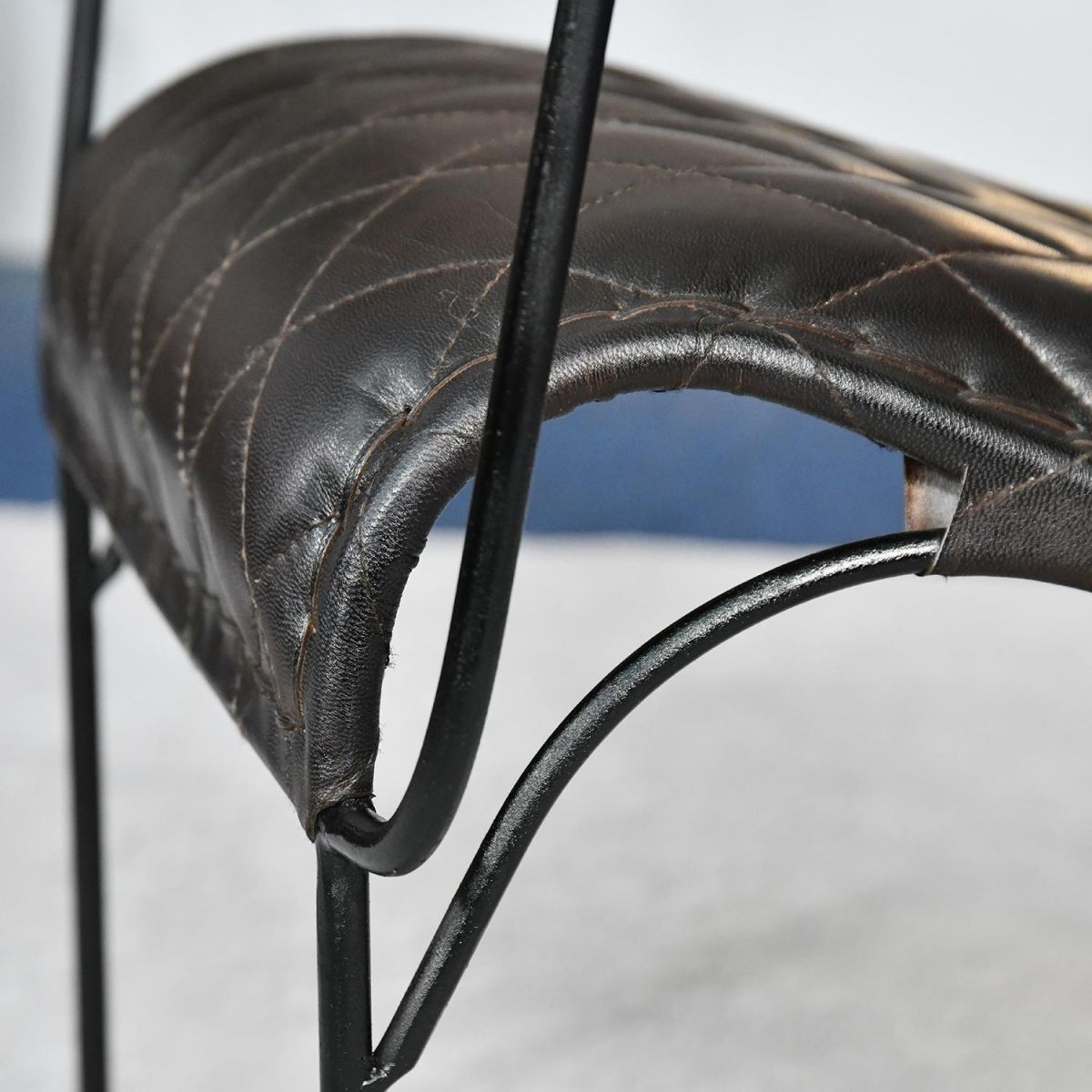 Close up of metal frame and leather seat 