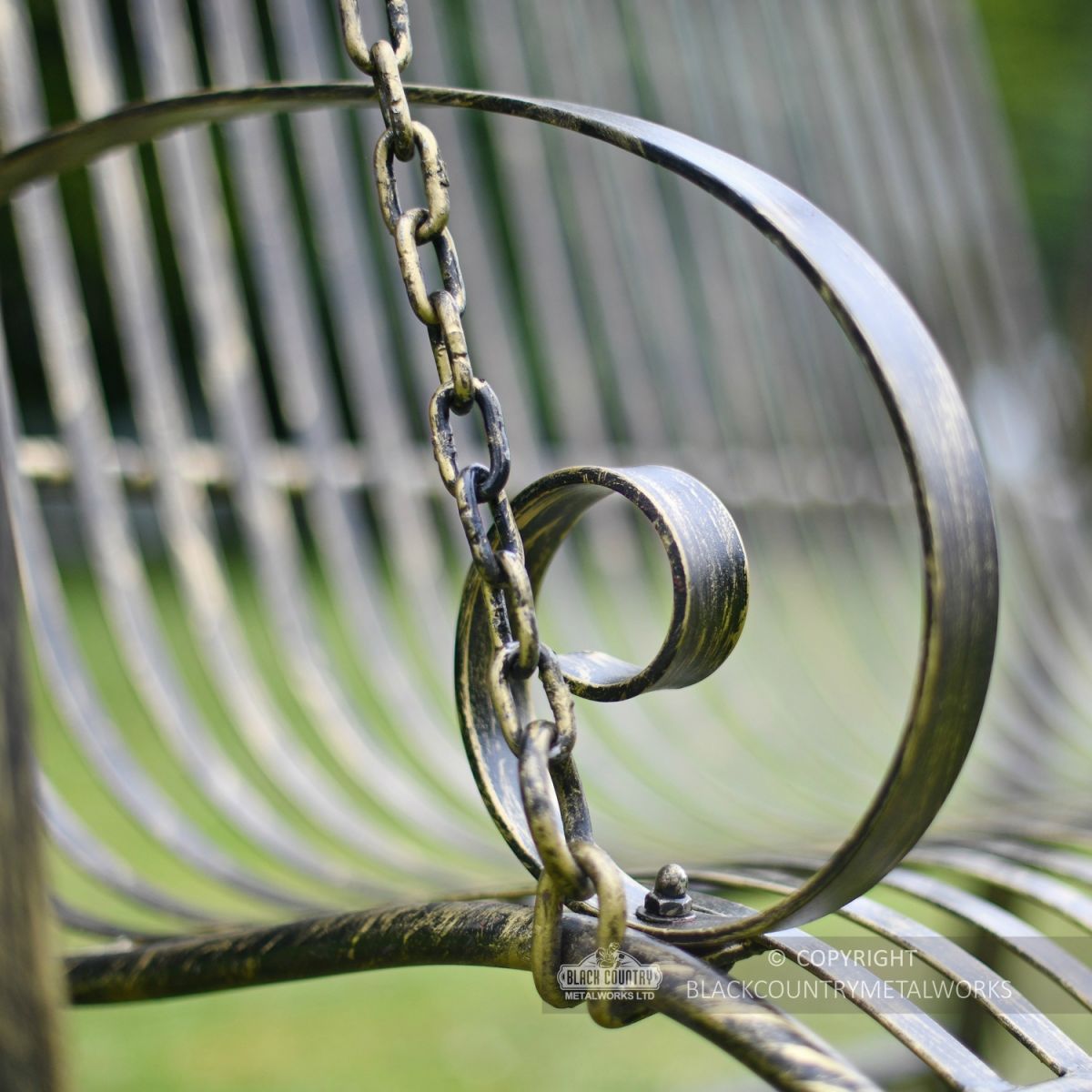 Black and gold blacksmith forged arm rest on swing seat