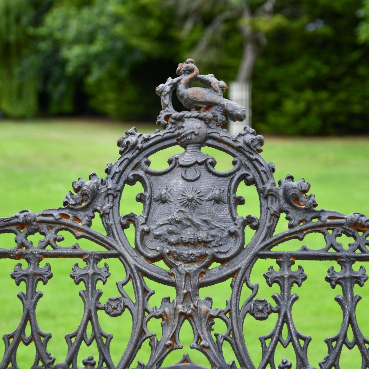 Close up of Aged Black Cast Iron Gothic Motif on Backrest of Bench Close up of Aged Black Cast Iron Gothic Motif on Backrest of Bench