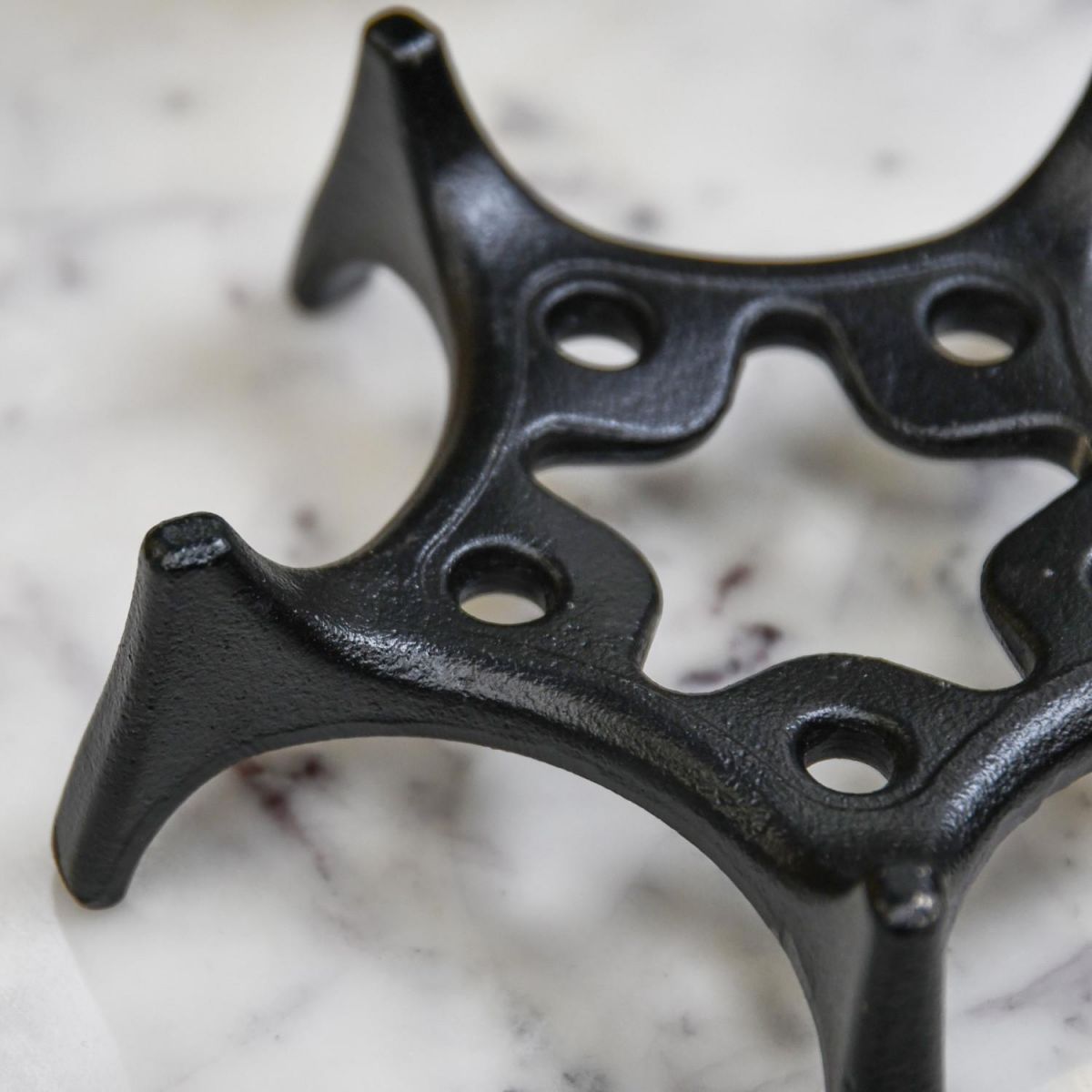 Close-Up of Black Cast Iron Japanese Star Teapot Stand