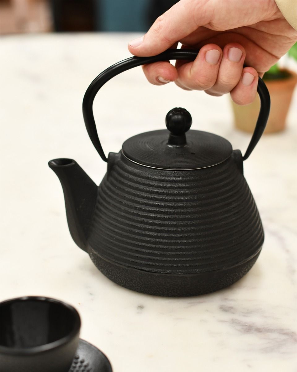 Black Teapot In Use 