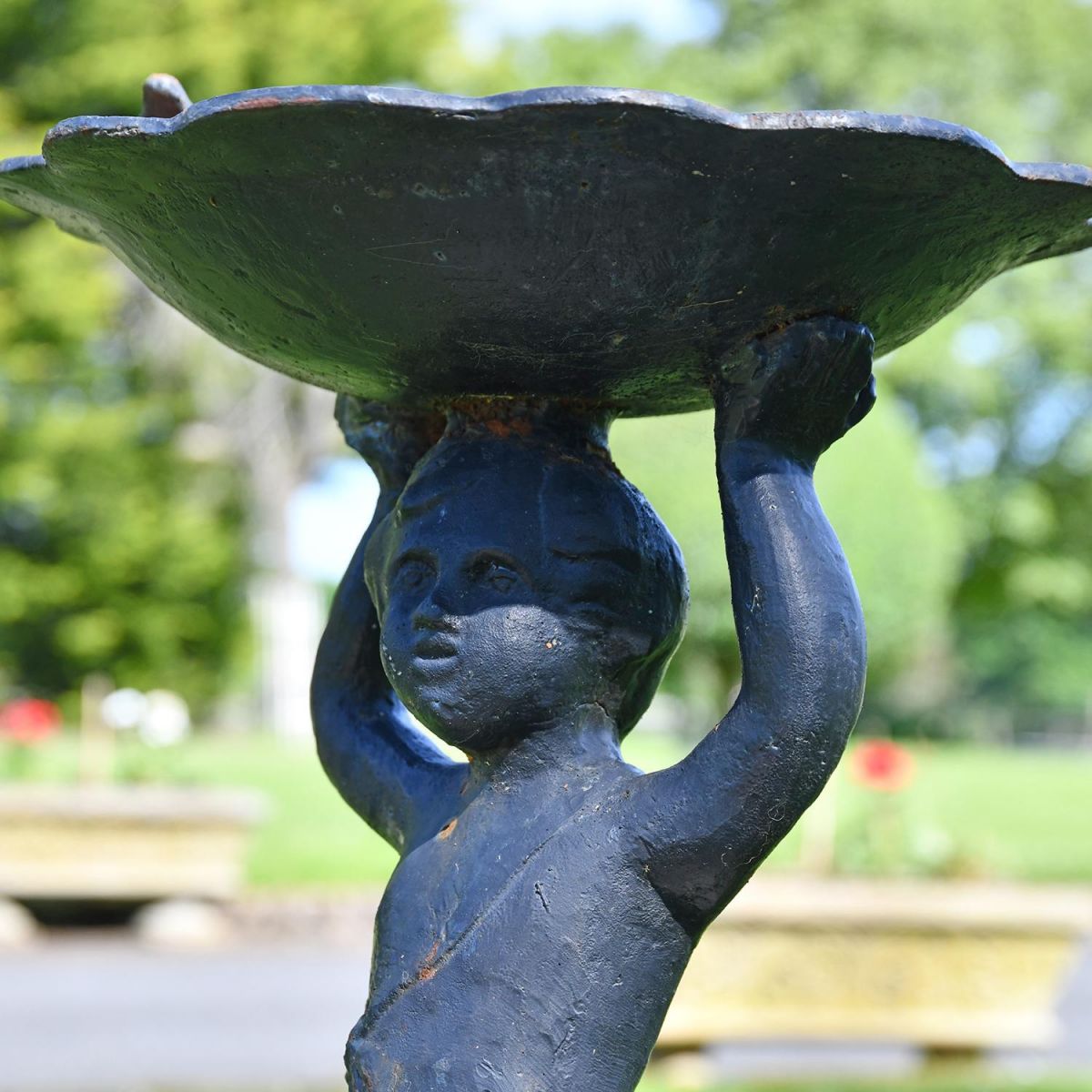 Close-up of the Black Cherub Design on the Bird Bath Close-up of the Black Cherub Design on the Bird Bath