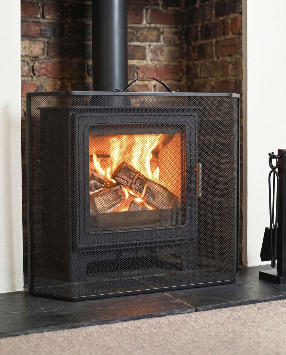 Black Contemporary Curved Fire Guard with Handle In A Fireplace Setting Digital Illustration