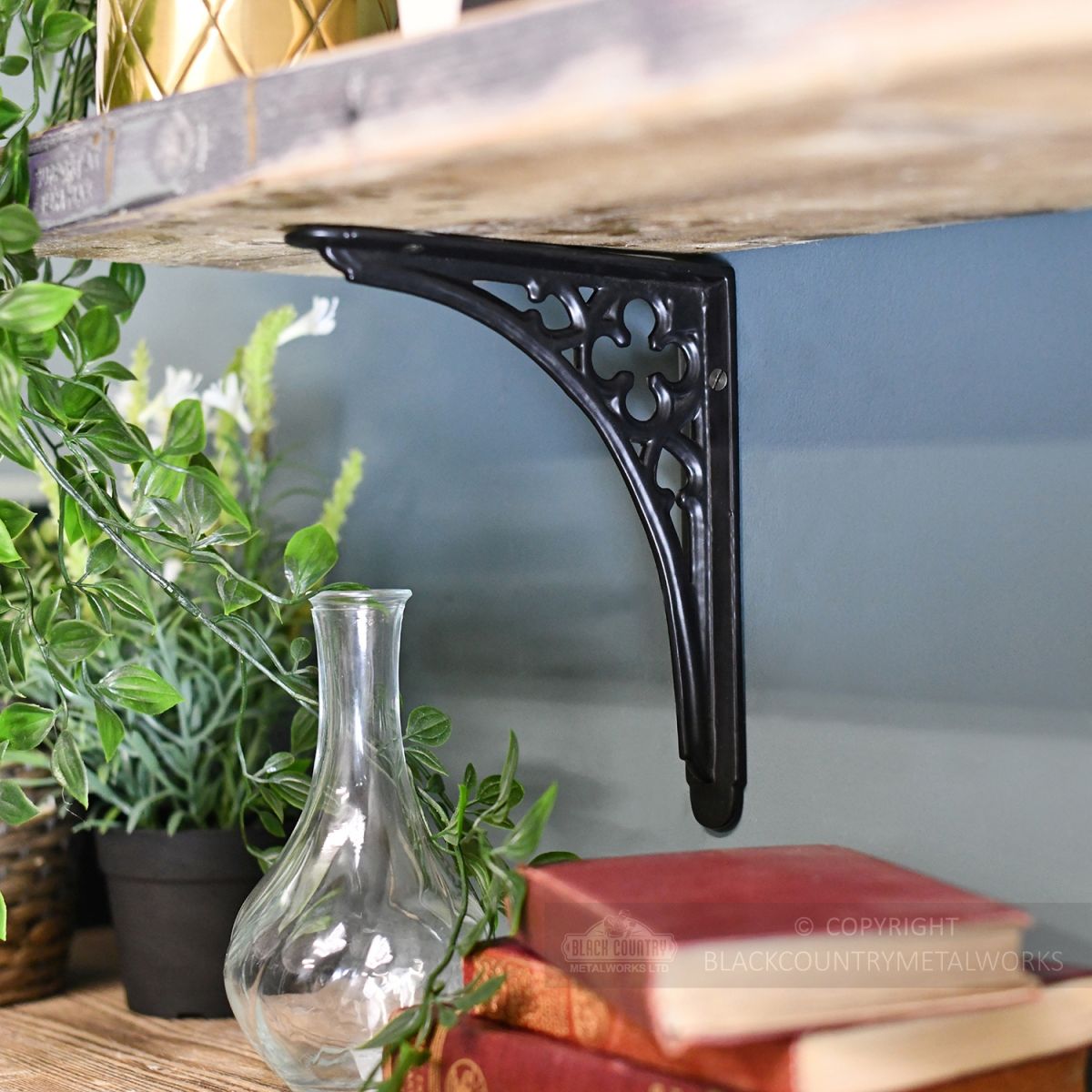 Black Shelf Bracket in Situ Holding up a Wooden Shelf Black Shelf Bracket in Situ Holding up a Wooden Shelf