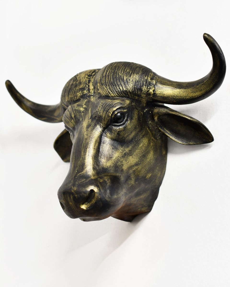 Angled view of gold animal head wall bust