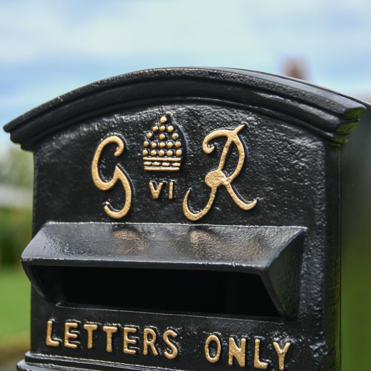 Close-Up of Gold King George Motif on Black Post Box