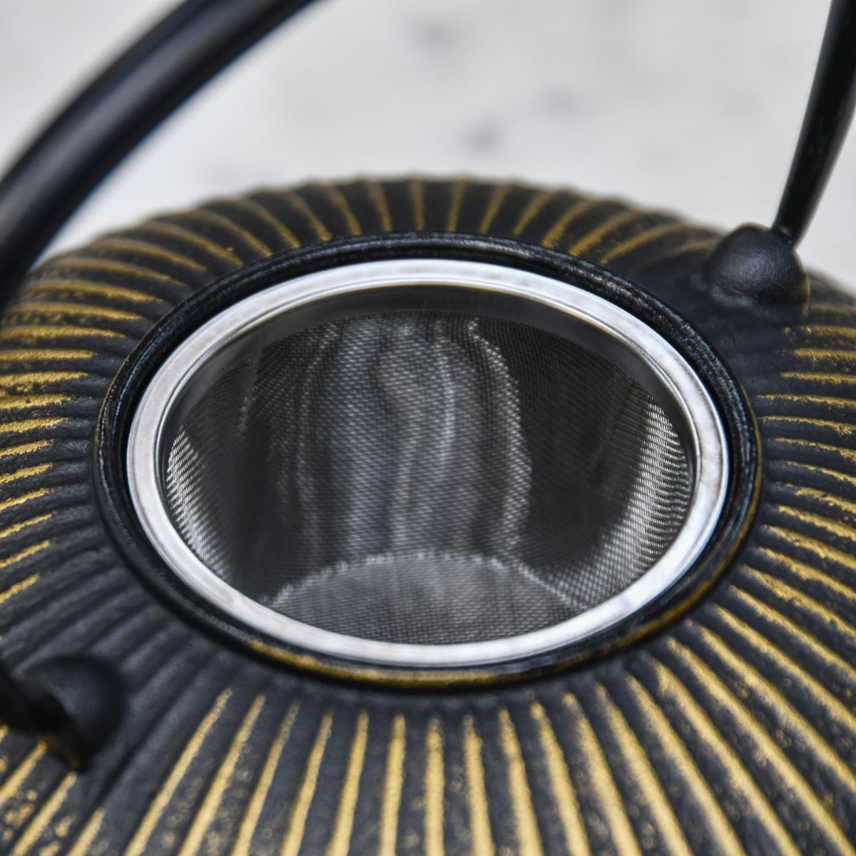 Close-Up of Tea Infuser on Cast Iron Teapot Close-Up of Tea Infuser on Cast Iron Teapot