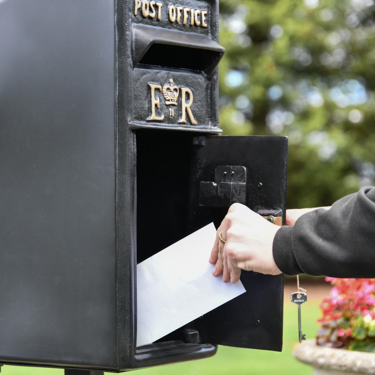 Front Opening in Use on Freestanding Black Post Box Front Opening in Use on Freestanding Black Post Box