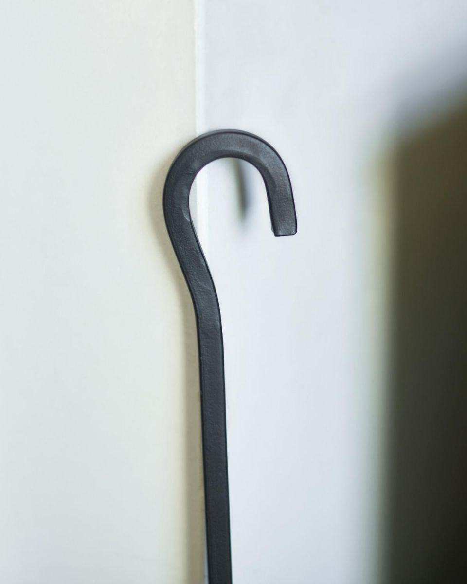 Close Up Of Black Hooked Fireside Brush Hooked Handle