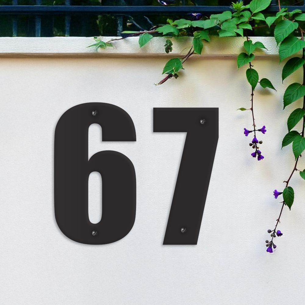 Black Individual House Numbers - Impact Font on garden wall Black Individual House Numbers - Impact Font on garden wall