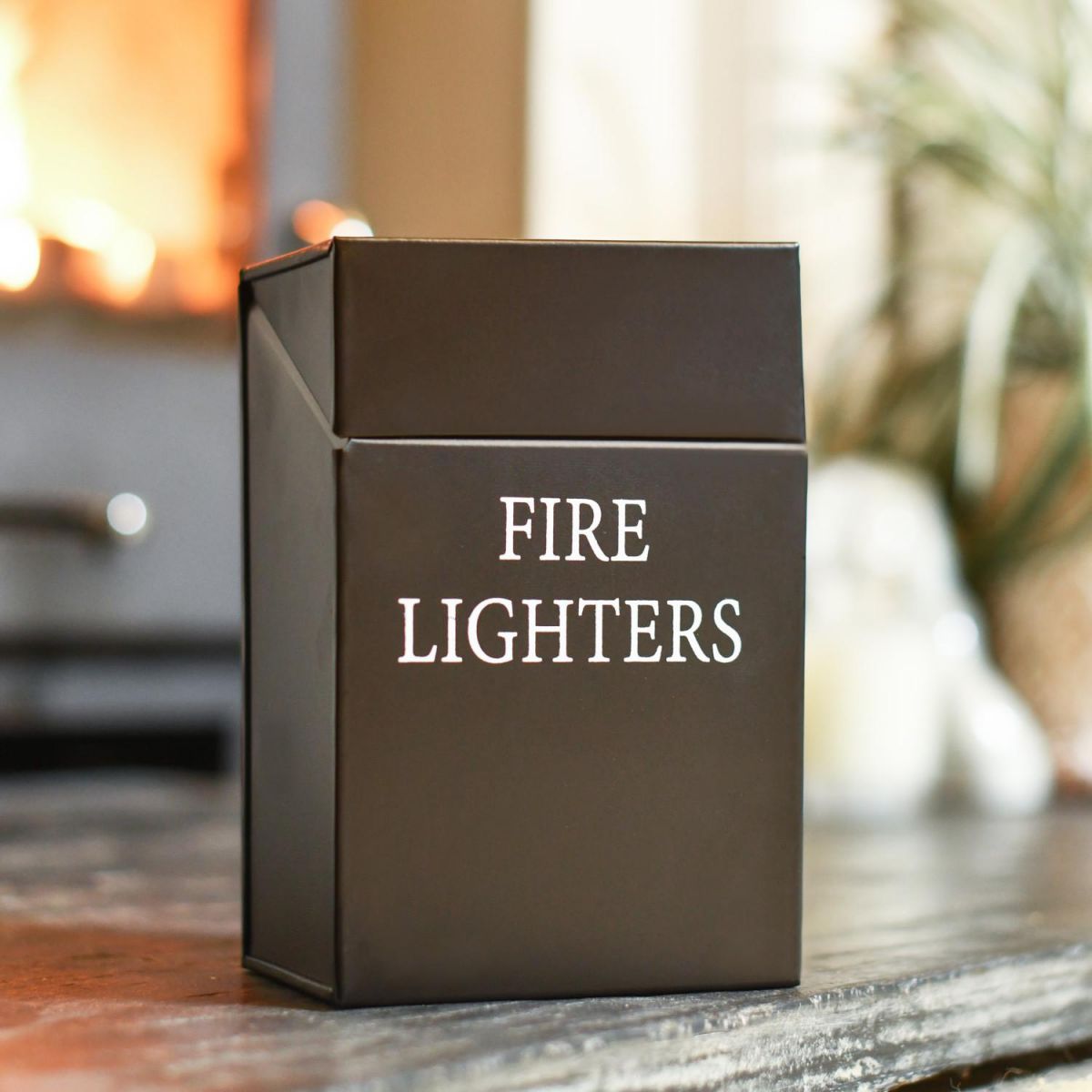 Black Metal "Fire Lighters" Holder In A Fireside Setting Black Metal "Fire Lighters" Holder In A Fireside Setting