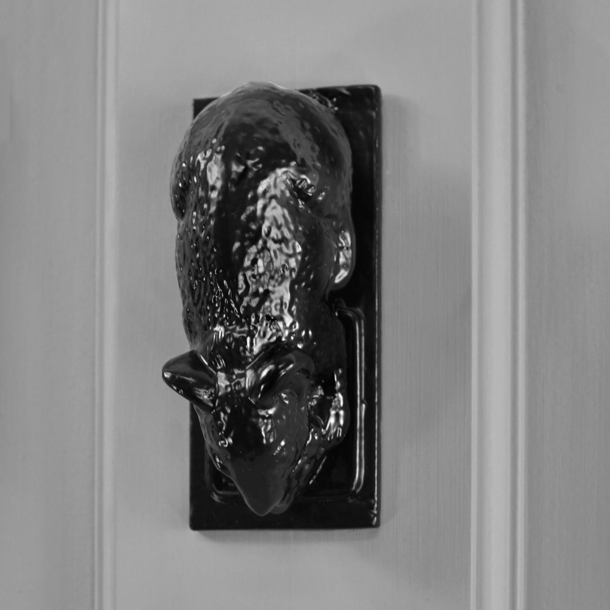 Black mouse door knocker on grey door Black mouse door knocker on grey door