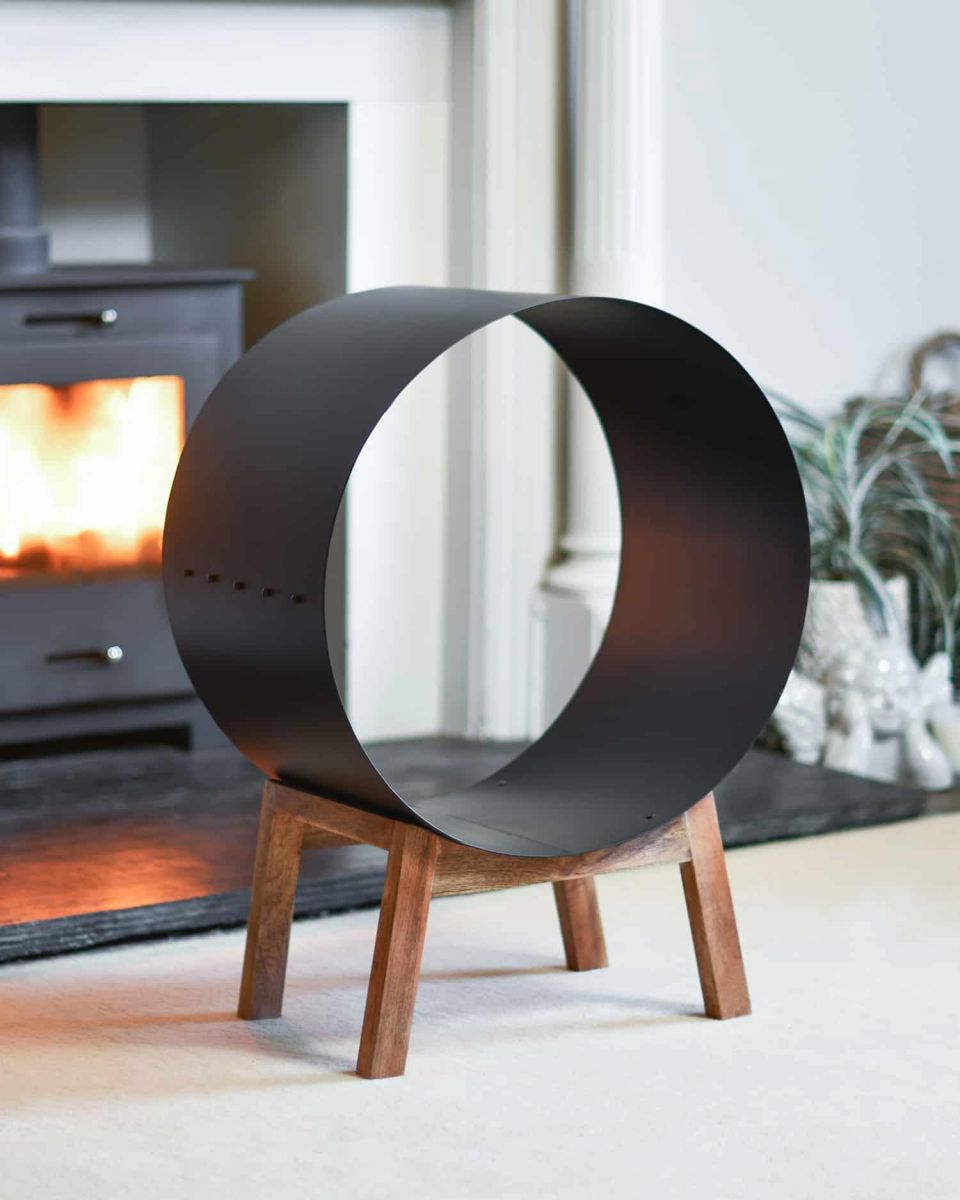 Black Round Steel "Barrel" Log Holder with Wooden Legs in Situ Black Round Steel "Barrel" Log Holder with Wooden Legs in Situ