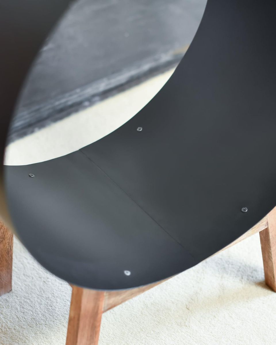 Close-Up of Black Round Steel "Barrel" Log Holder with Wooden Legs Close-Up of Black Round Steel "Barrel" Log Holder with Wooden Legs