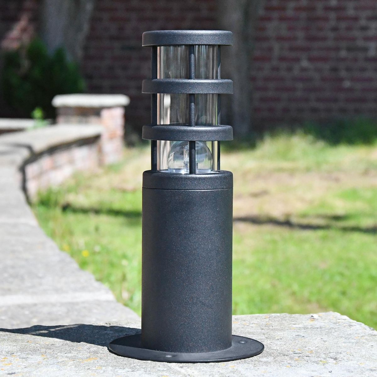 Black Stainless Steel Contemporary Pedestal Light in Situ on a Driveway