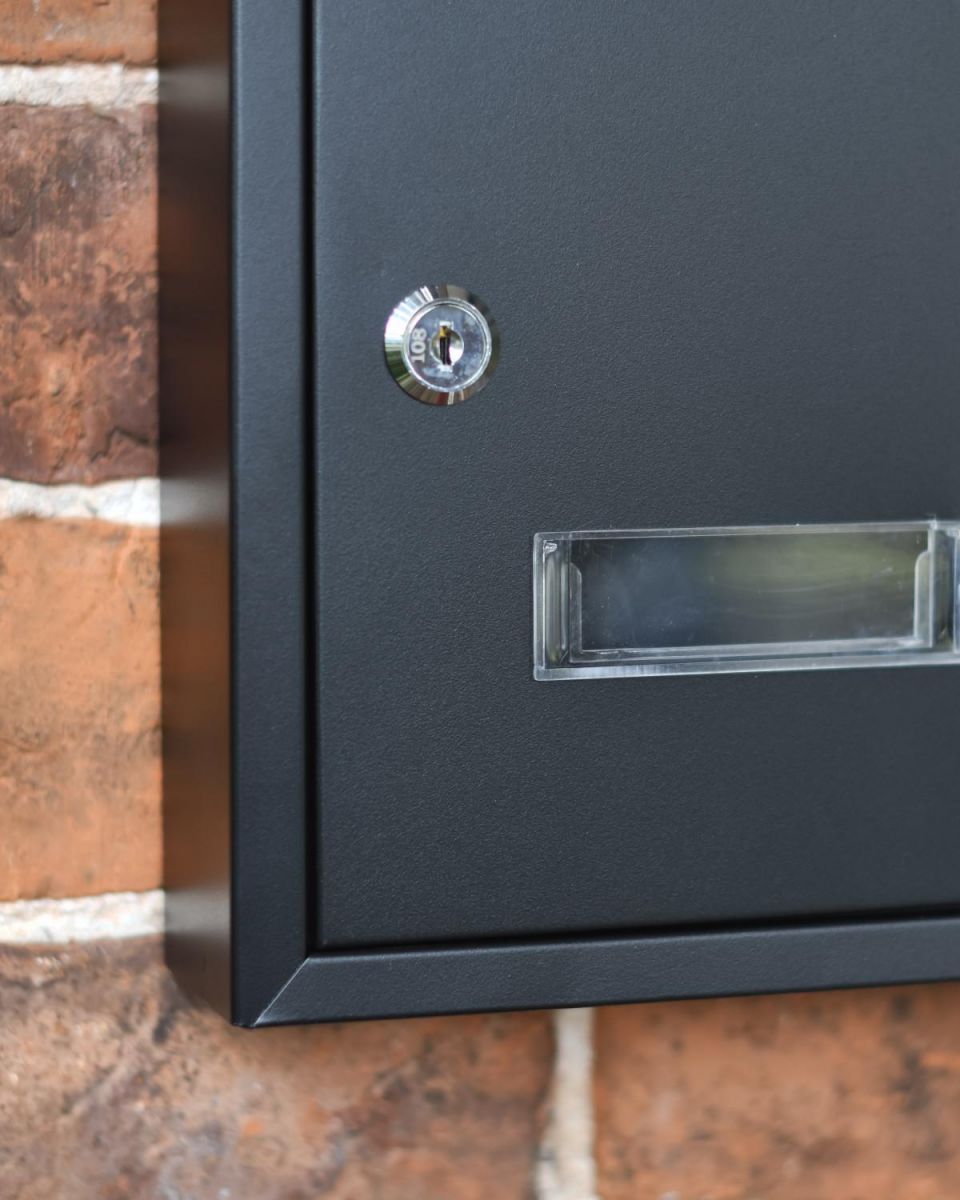 Close-up of the Lock on the Front of the Wall Mounted Post Box Close-up of the Lock on the Front of the Wall Mounted Post Box