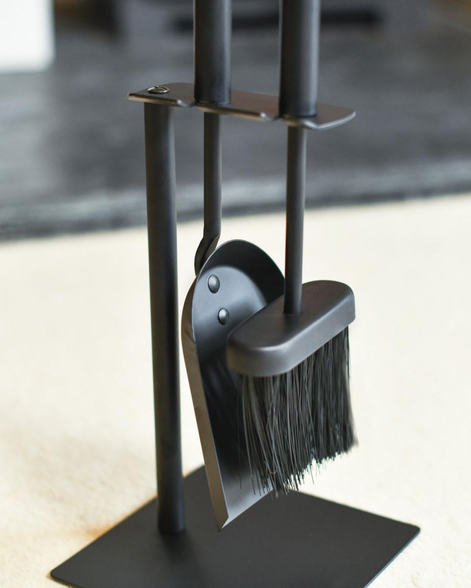 Close Up Of Black Suspended Brush & Pan Set Tools In Situ