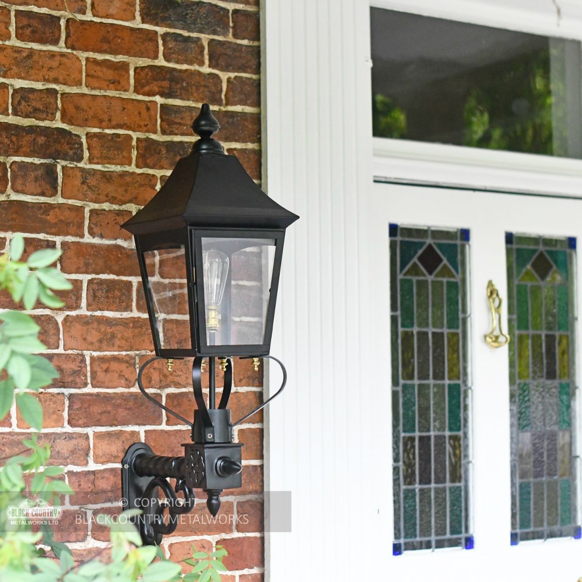 Black Traditional Victorian Wall Light Installed In Front Porch