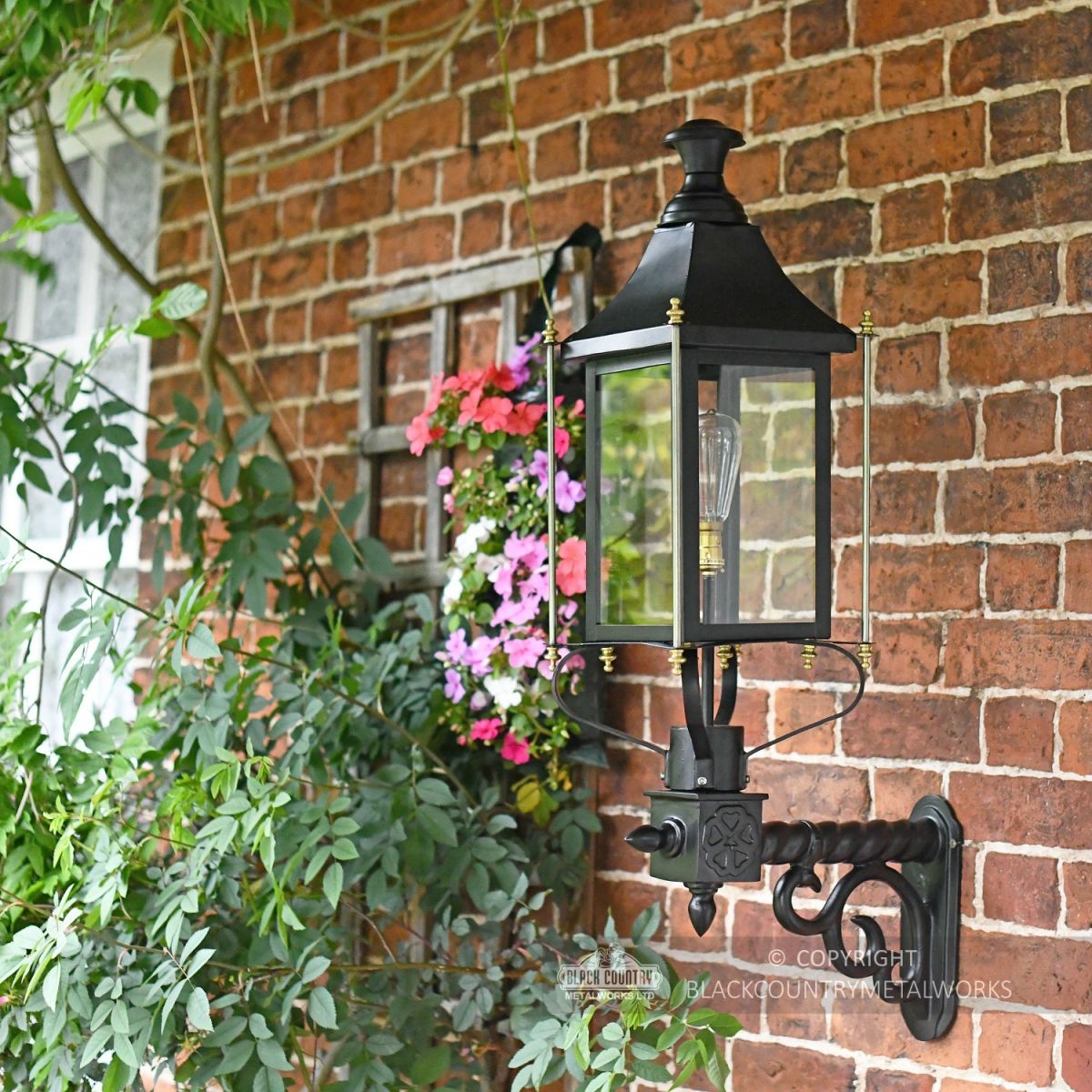 Black Victorian Wall Lantern With Brass Decoration On Wall Bracket