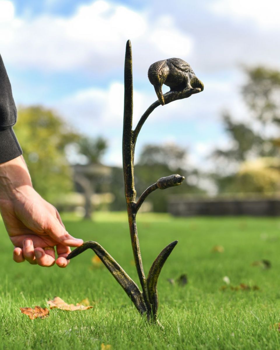 Scale image of black and gold Kingfisher on reed sculpture