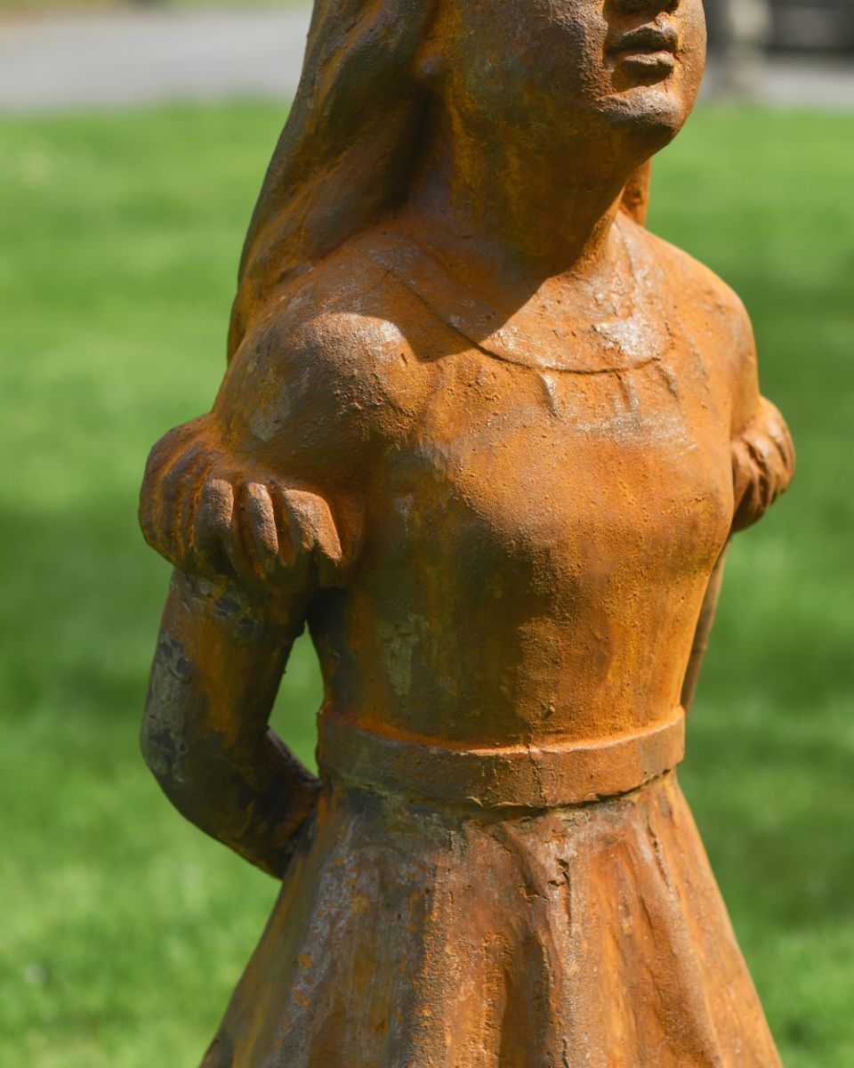 close up of body detail on cast iron garden statue
