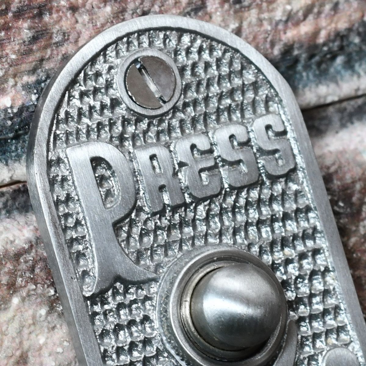 Close up image of PRESS Wording on front door bell