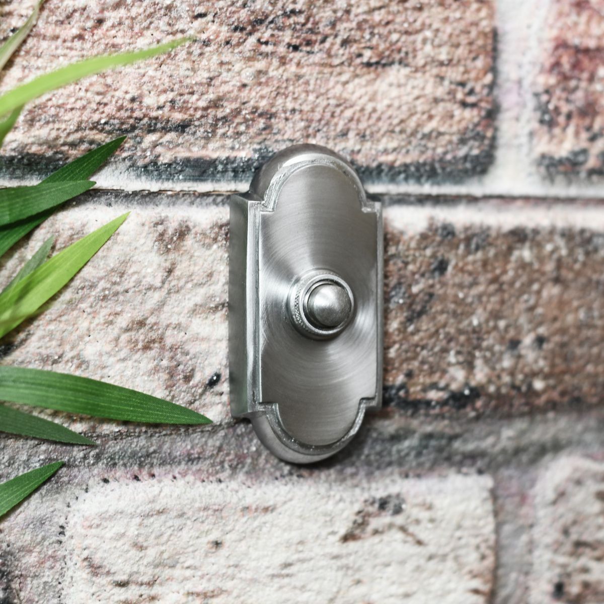 Front door bell switch finished in satin chrome