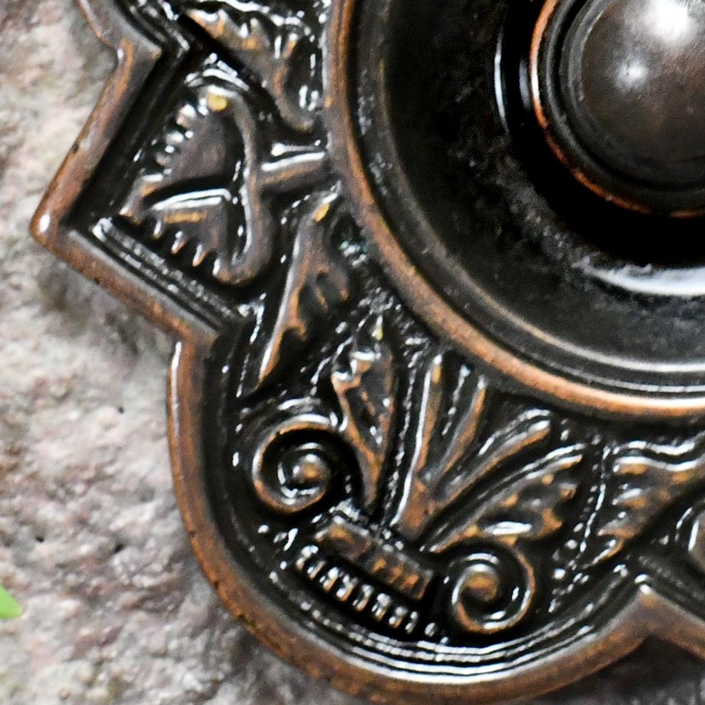 Detailed image of ornate cast pattern on Burnished Copper Bell Push