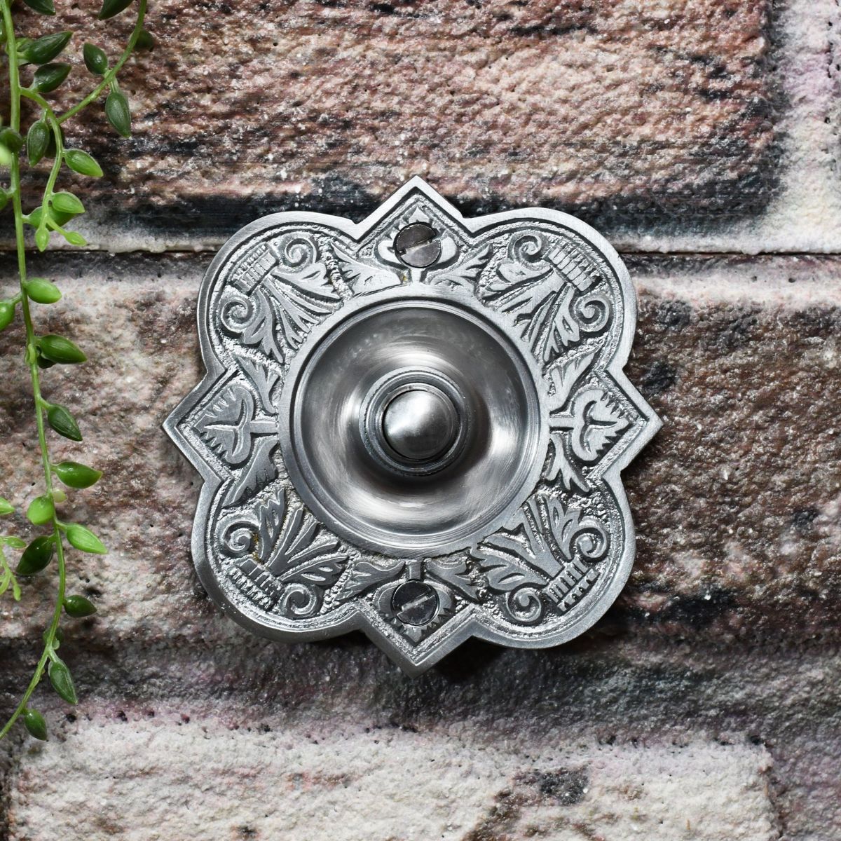 Ornate door buzzer with period pattern