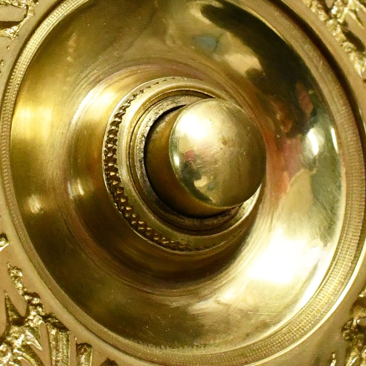 Close up image of brass door push button