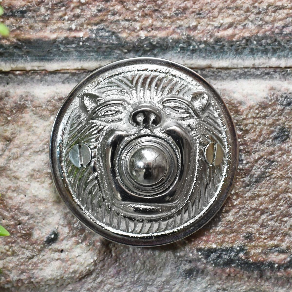 Bright Chrome bell push on brick wall Bright Chrome bell push on brick wall
