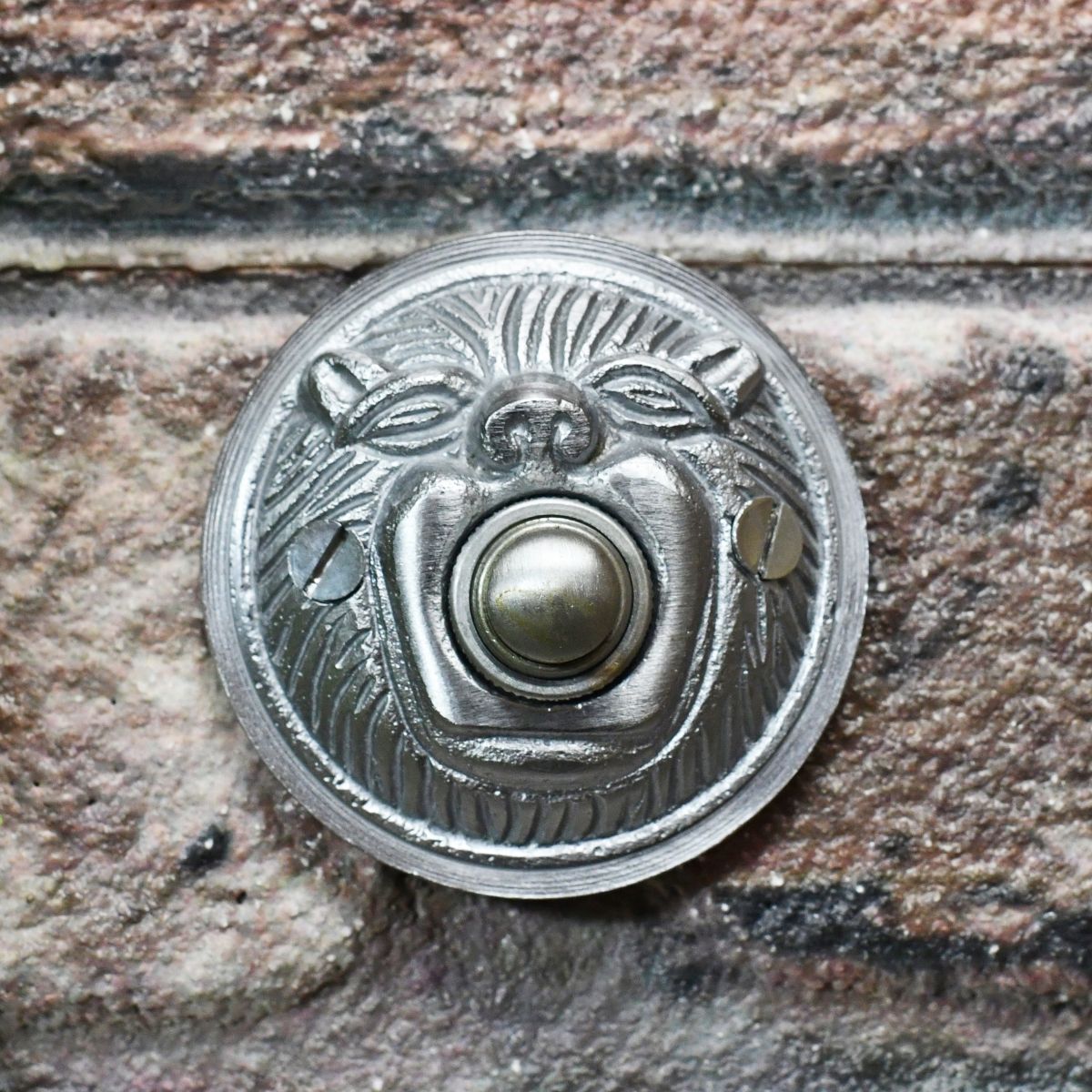 Satin Chrome door bell on brick wall