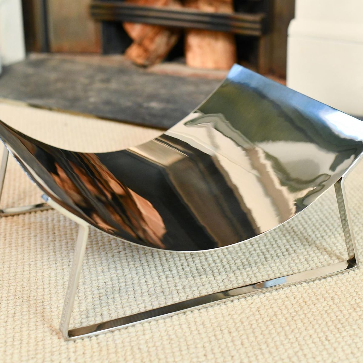 Close-up of the Top of the Bright Chrome Curved Contemporary Log Holder Close-up of the Top of the Bright Chrome Curved Contemporary Log Holder