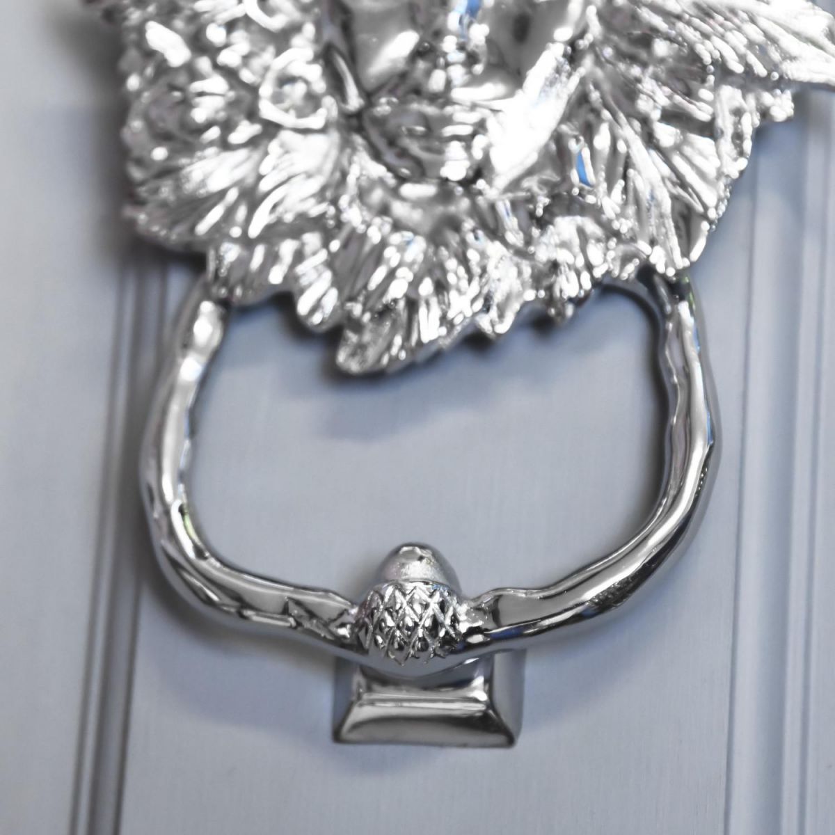 Close-Up of Door Knocker Handle on Bright Chrome Maiden Design