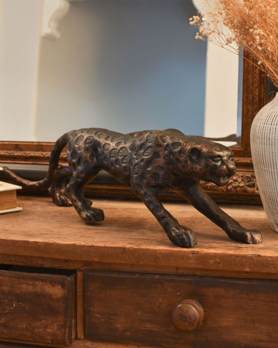 Three quarter view of bronze leopard sculpture