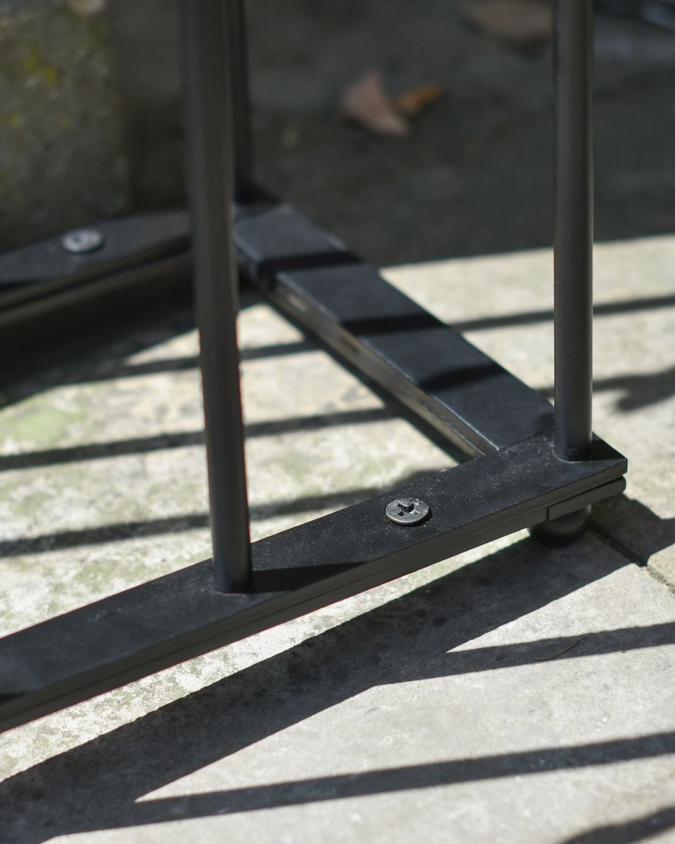 Close up of base detail on black boot rack Close up of base detail on black boot rack