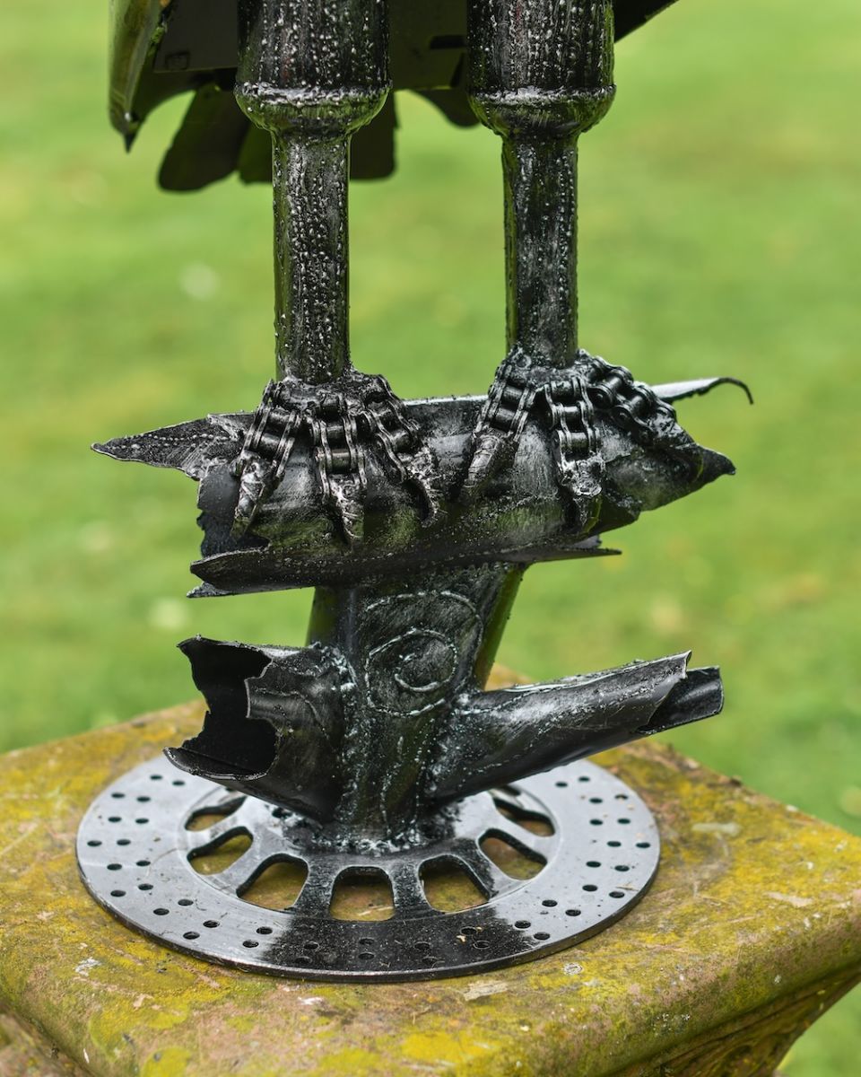Close up of feet detail recycled metal art sculpture Close up of feet detail recycled metal art sculpture