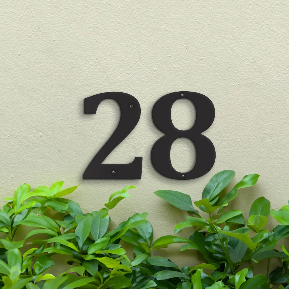 Black Individual House Numbers - Cambria Font on green wall