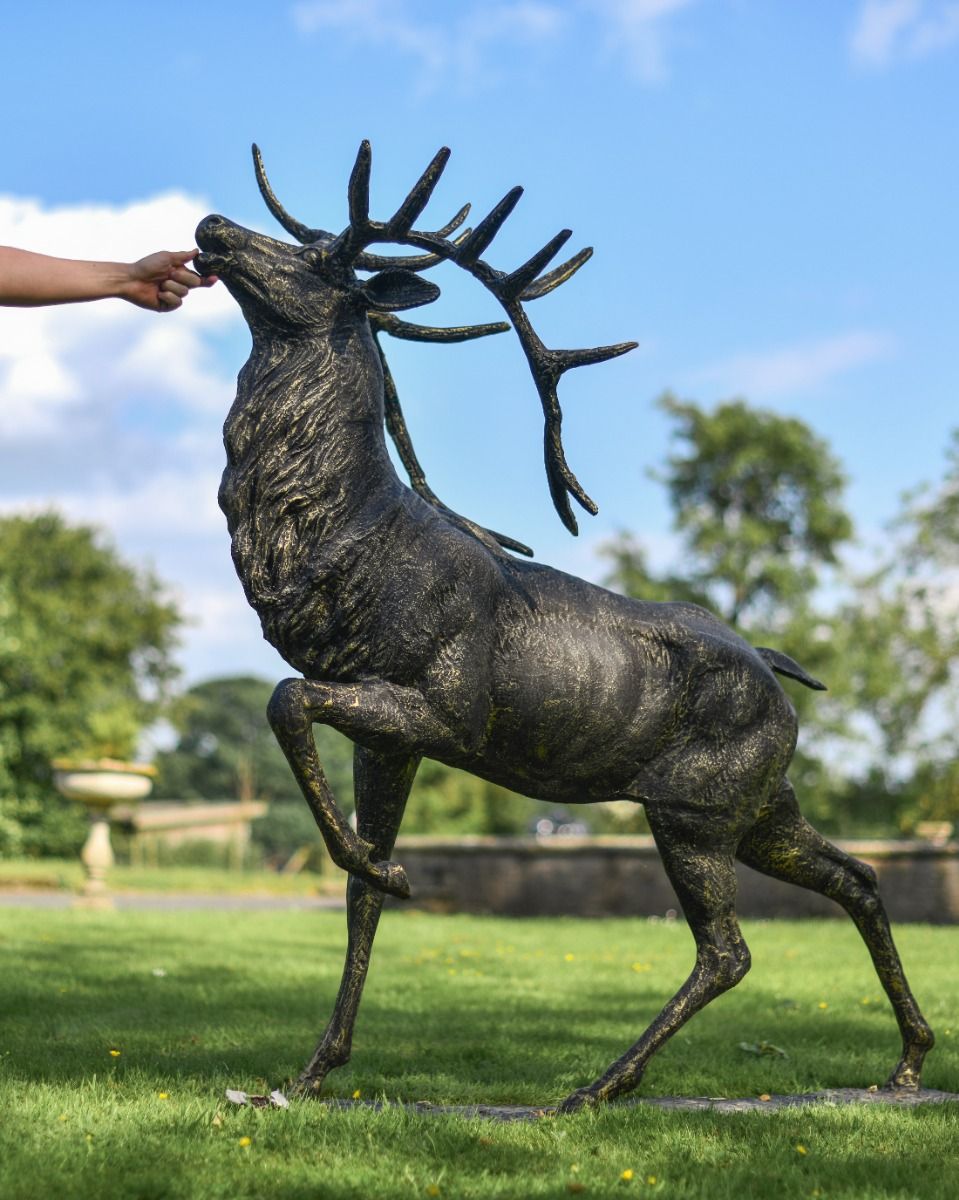 Cast Iron Evander Stag Sculpture in Antique Gold with Hand for Scale