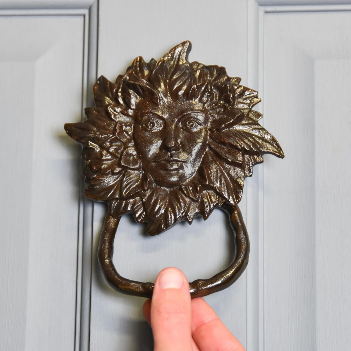 Scale Shot of Black Cast Iron "Green Women" Door Knocker